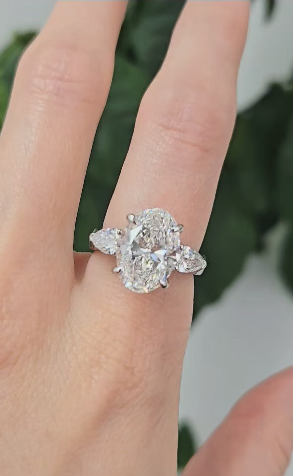 oval three stone ring with pear diamonds